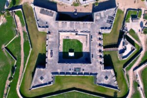 Top-down aerial view of Castillo de San Marcos in St. Augustine, Florida, showcasing its symmetrical star fort layout, central courtyard, and surrounding moat.