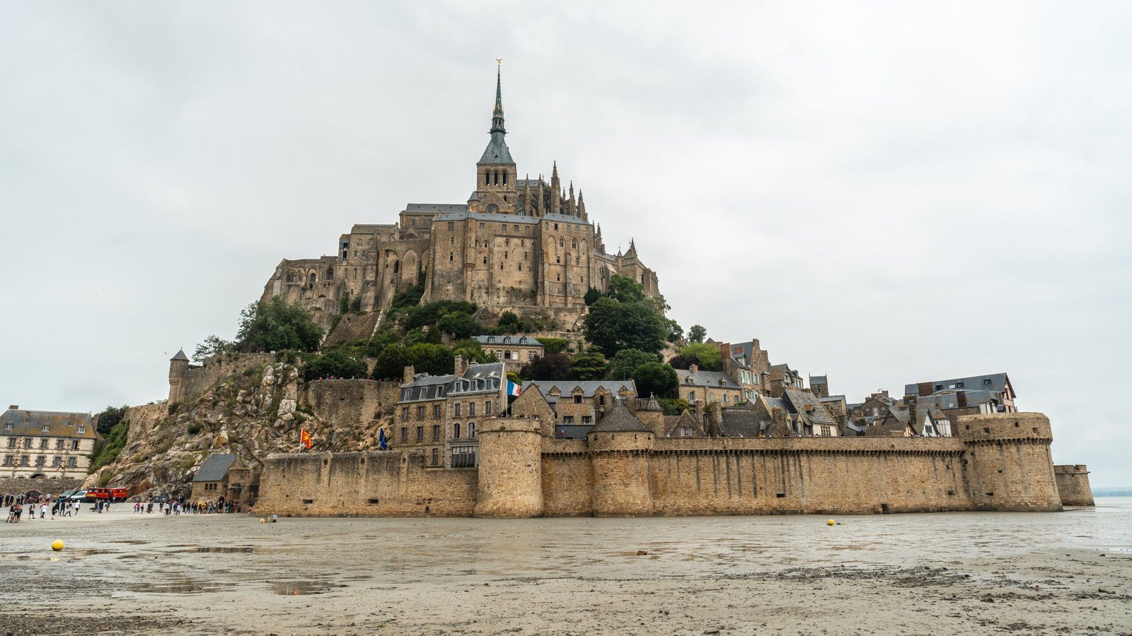 View of Saint-Michel rising above medieval walls at low tide.