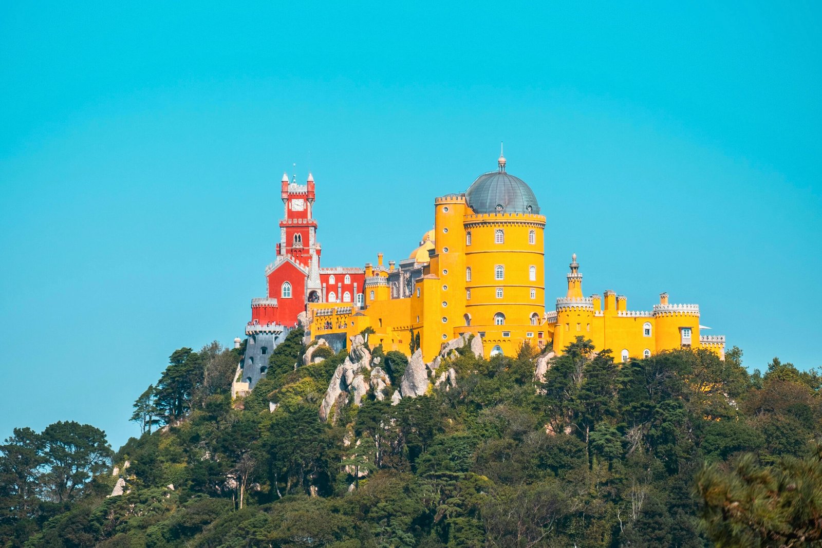 Vibrant Facade of Pena Palace on a Clear Day in Sintra.