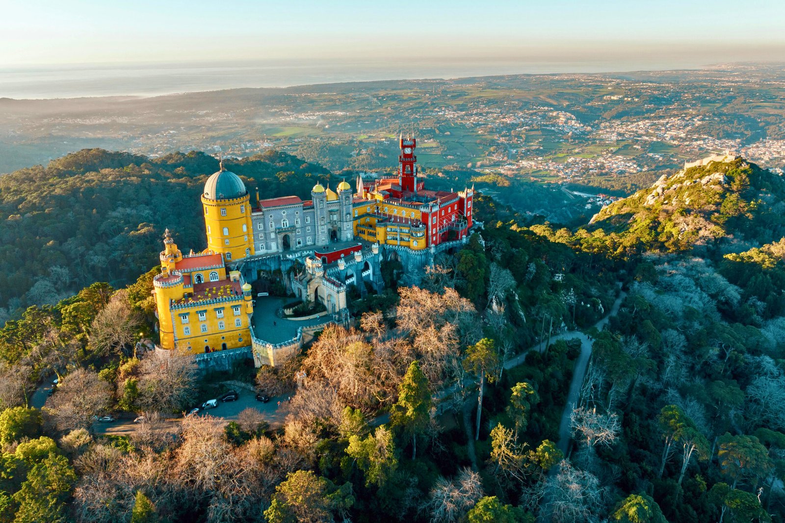 Sunrise over Pena Palace: a fairytale fortress crowned by the rolling hills of Sintra.