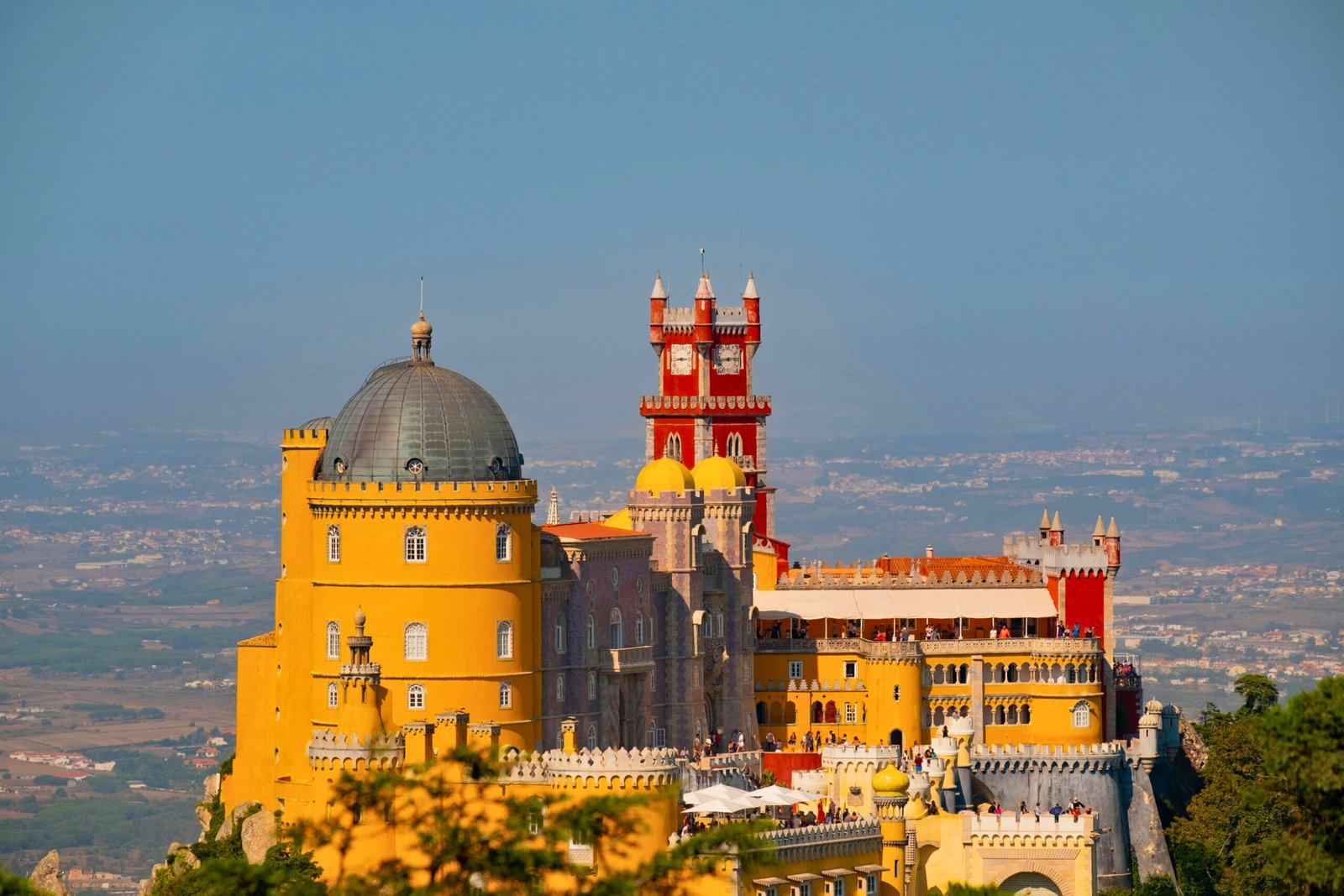 Bold colors and intricate architecture: a clear view of Pena Palace’s stunning silhouette above Sintra.
