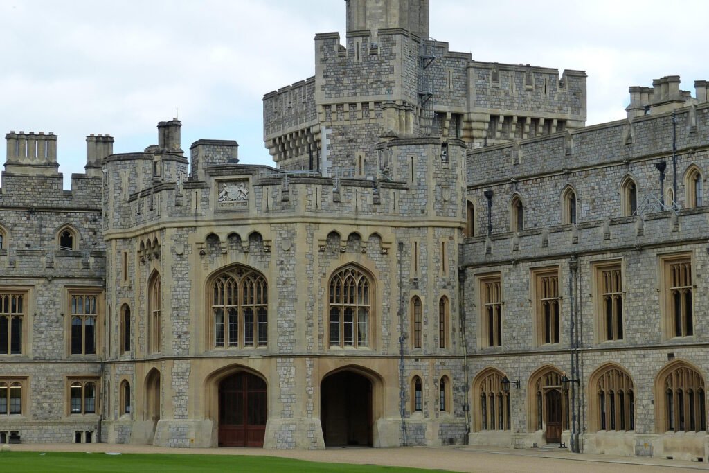 Close-up of Windsor Castle’s stone walls, towers, and arched windows with intricate details.