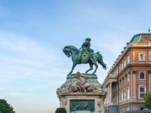 Buda Castle equestrian statue under blue sky, historic landmark