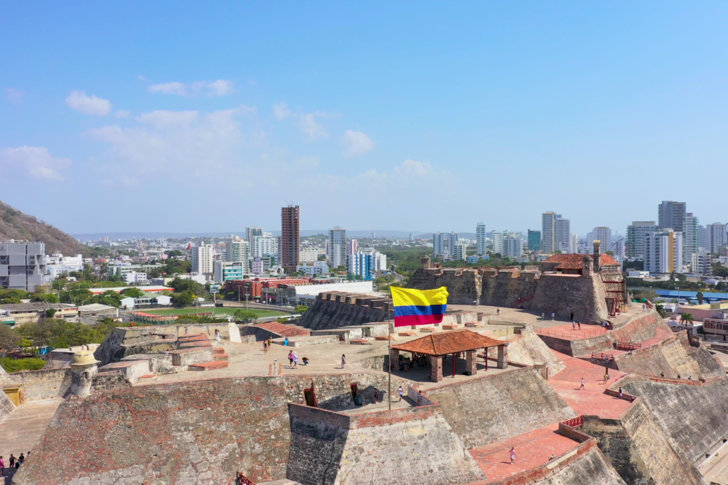 View of Castillo San Felipe de Barajas fortress with Colombian flag and Cartagena city skyline