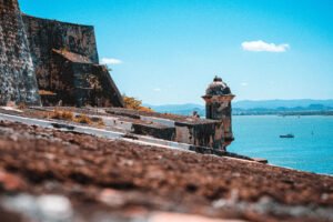Castillo San Felipe de Barajas fortress overlooking Caribbean Sea and distant mountains on a sunny day.