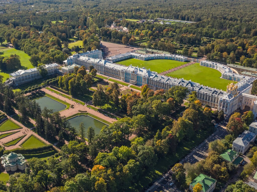 Aerial view of Catherine Palace and its landscaped gardens in Tsarskoye Selo, Russia, showcasing the grand Rococo architecture and surrounding parkland.