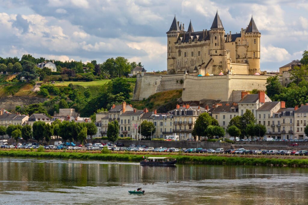 Château de Saumur overlooking the Loire River and the rooftops of the town on a partly cloudy afternoon