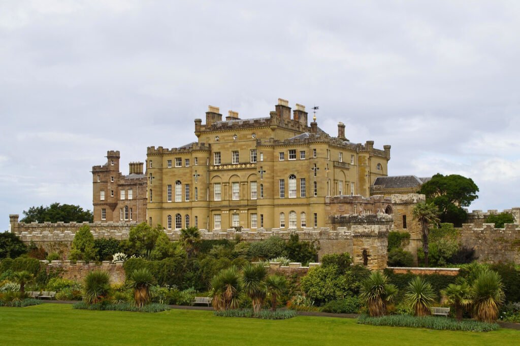 Elegant facade of Culzean Castle surrounded by manicured gardens and lush greenery in Ayrshire, Scotland