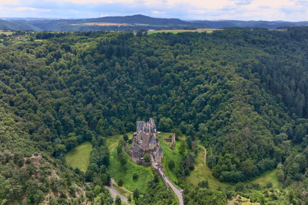 Aerial view of Eltz Castle nestled deep in the forested hills of western Germany