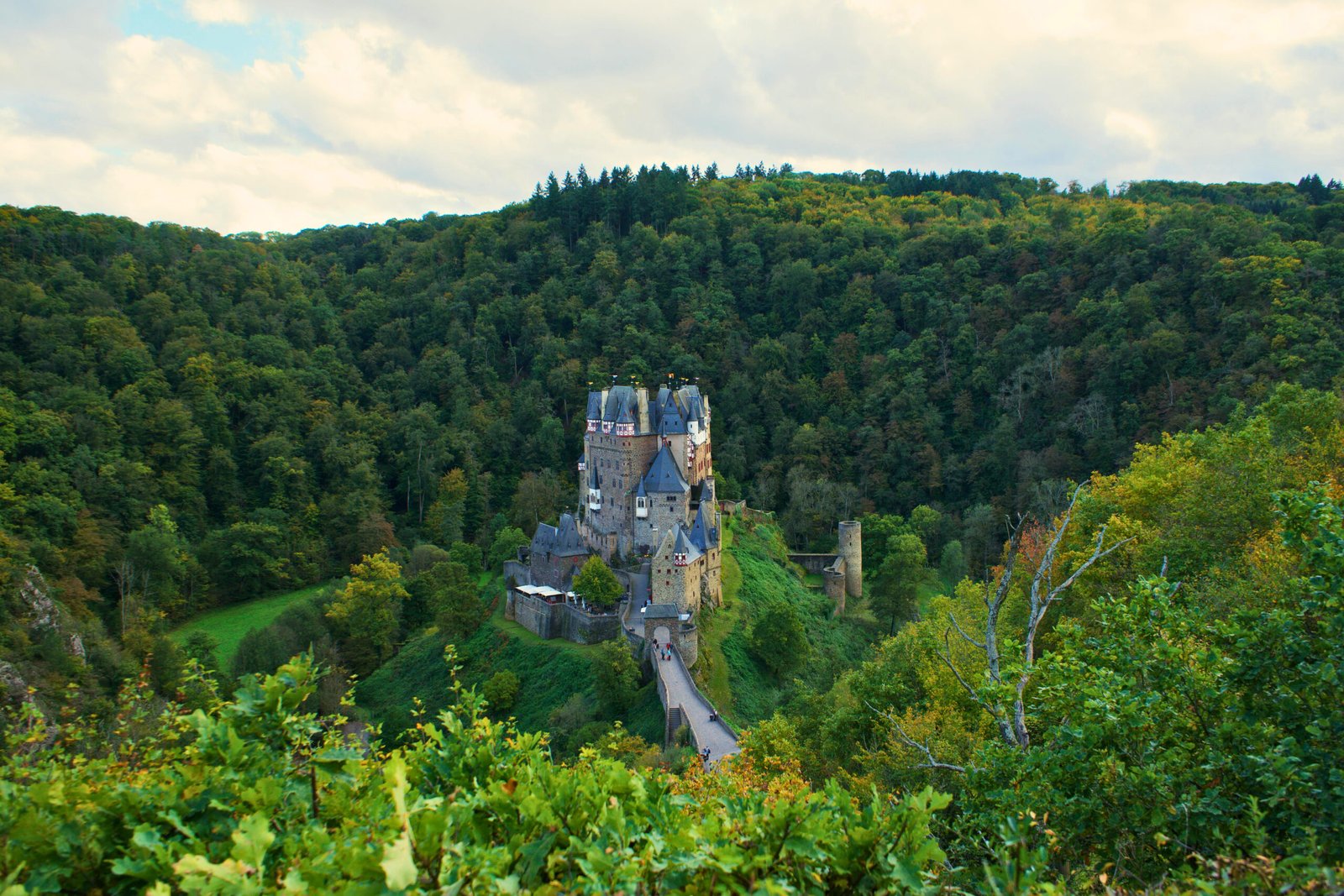 Autumn View of Eltz Castle from a Scenic Forest Trail