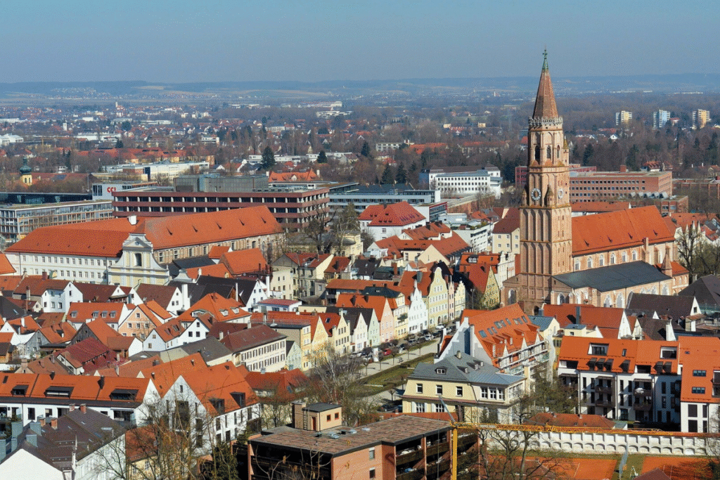 Aerial view of Landshut’s Old Town with St. Martin’s Church and its tall Gothic brick tower rising above colorful rooftops in Bavaria, Germany.