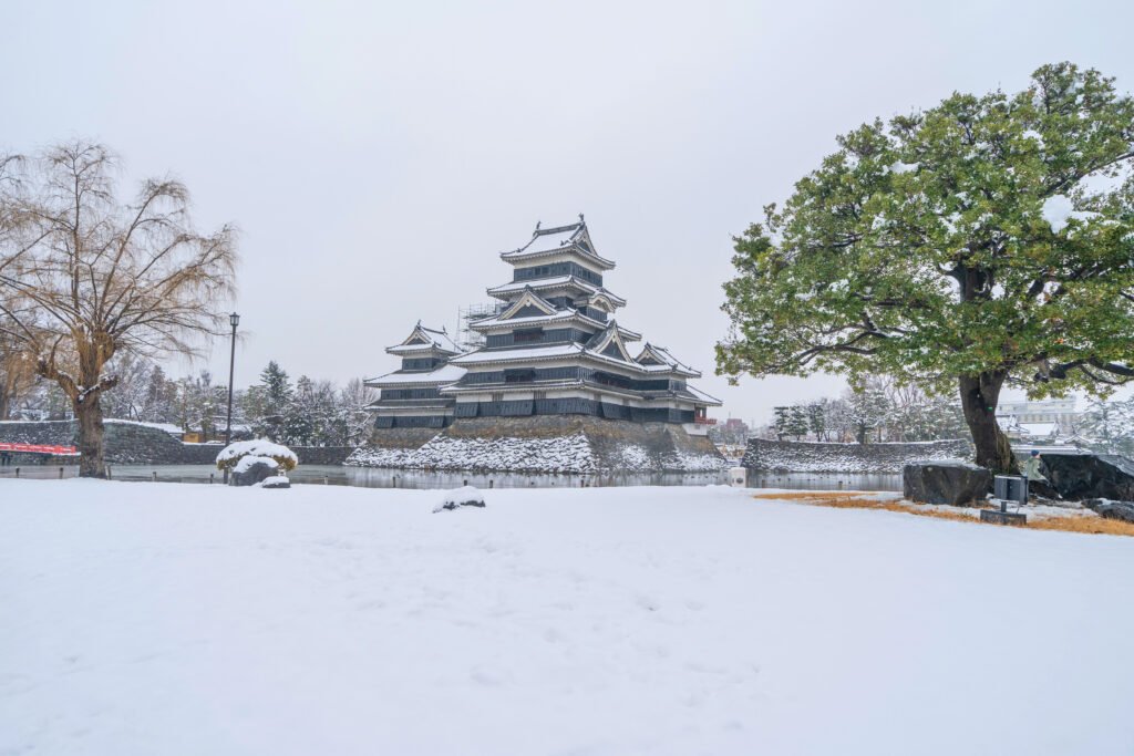 Matsumoto Castle surrounded by snow in winter landscape, Japan.