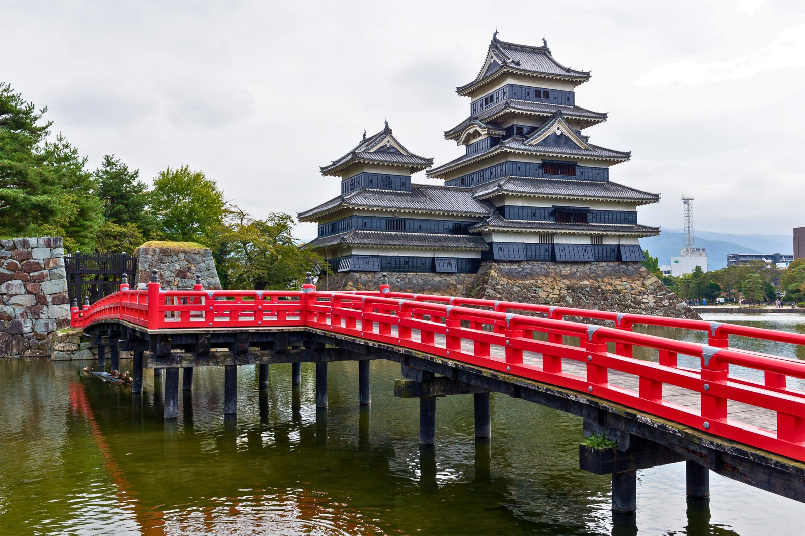 Red Bridge to Matsumoto Castle over Reflective Moat