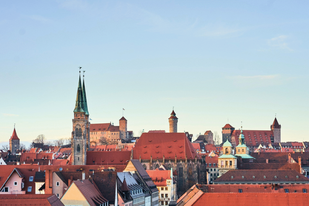 Panoramic view of Nuremberg’s Old Town with Kaiserburg Nürnberg rising above the red rooftops and historic churches.