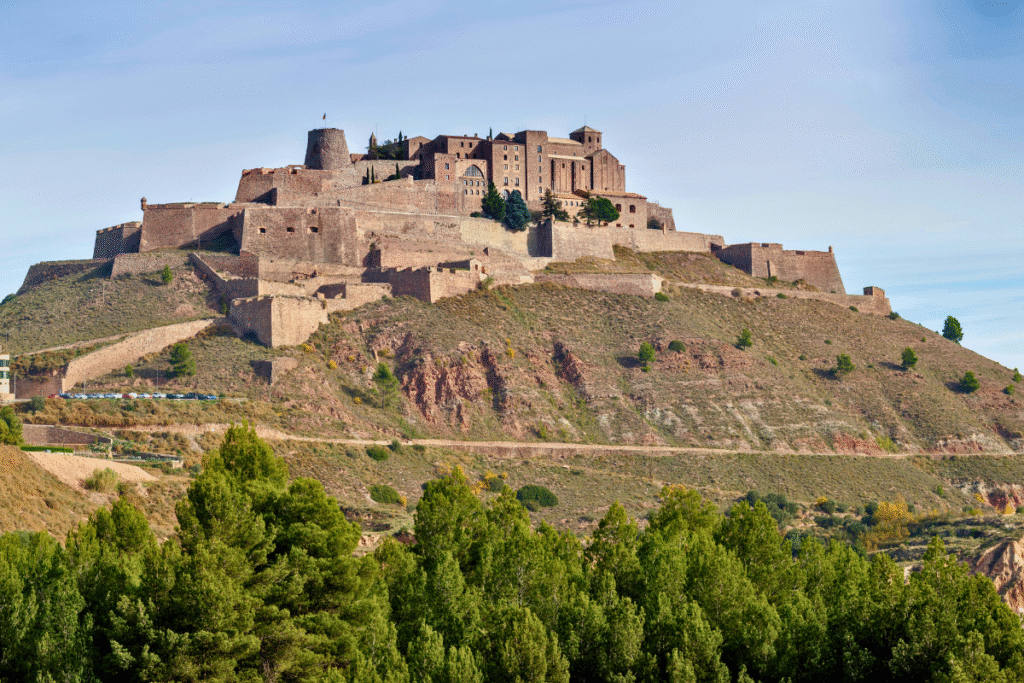Castle of Cardona perched atop a steep hill with multiple defensive walls in Catalonia, Spain