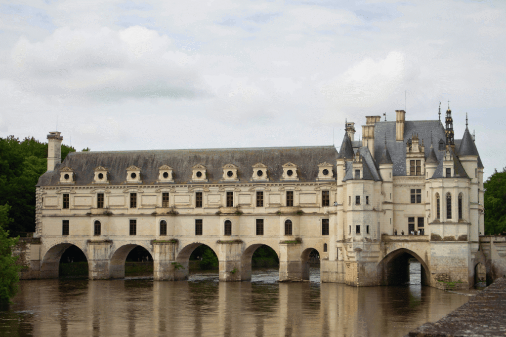 Château de Chenonceau spanning the River Cher, with its elegant arches and Renaissance façade reflected in the water.