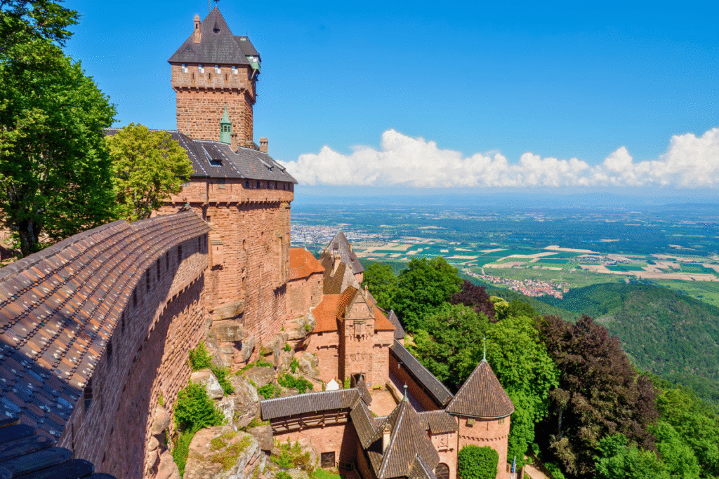 The ramparts and towers of Château du Haut-Kœnigsbourg overlooking the Alsace plains on a sunny day.