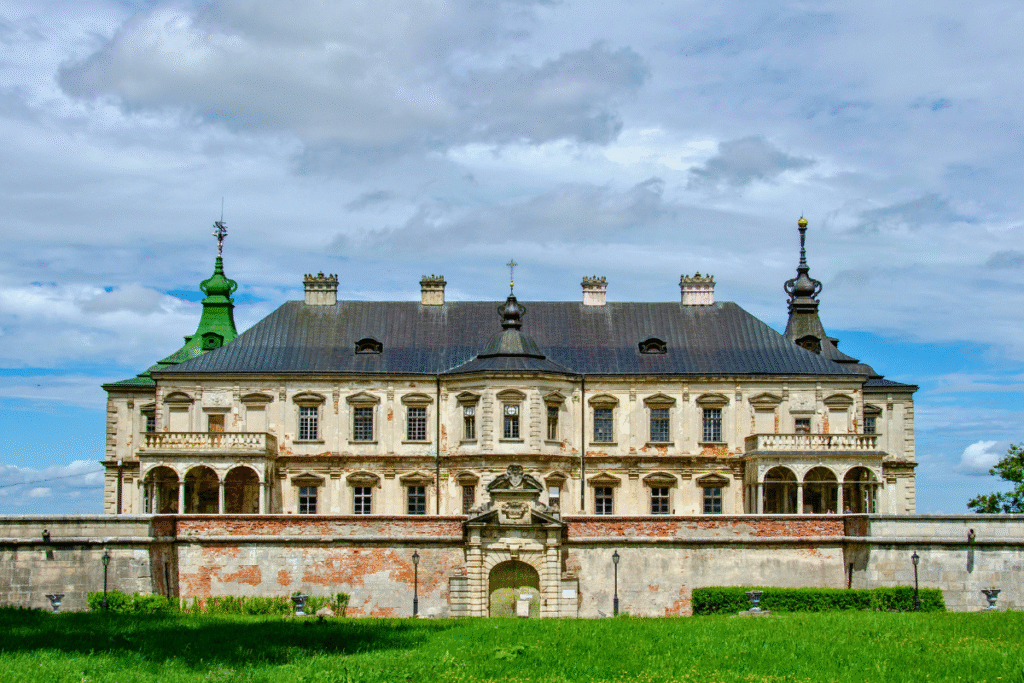 Front view of Pidhirtsi Castle in Ukraine, showcasing its grand Renaissance facade with ornate towers and weathered walls.