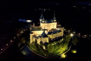 Aerial night view of Bojnice Castle Slovakia glowing with lights