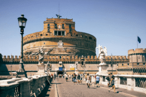 Tourists walking toward Castel Sant'Angelo in Rome on a sunny day