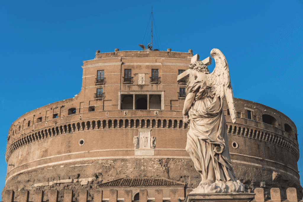 Castel Sant’Angelo with angel statue framed under blue sky in Rome