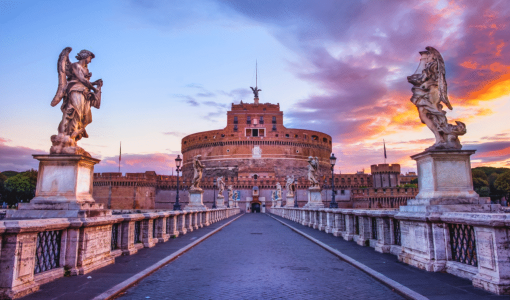Castel Sant'Angelo at sunset with angel statues and colorful sky in Rome