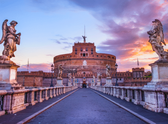 Castel Sant'Angelo at sunset with angel statues and colorful sky in Rome