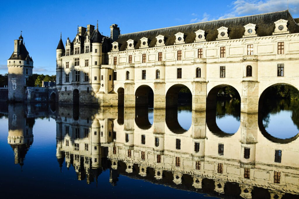 Chenonceau Castle’s arches and reflection on the Cher River, Loire Valley, France