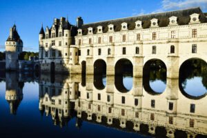 Chenonceau Castle’s arches and reflection on the Cher River, Loire Valley, France