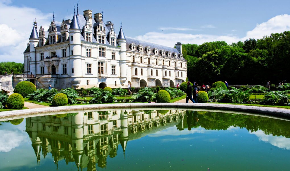 Chenonceau Castle reflected in pond with gardens, Loire Valley.