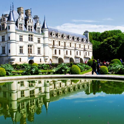 Chenonceau Castle reflected in pond with gardens, Loire Valley.