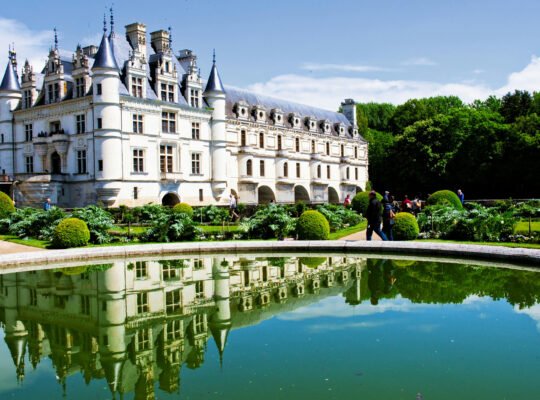 Chenonceau Castle reflected in pond with gardens, Loire Valley.