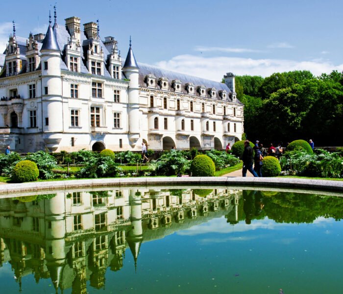 Chenonceau Castle reflected in pond with gardens, Loire Valley.
