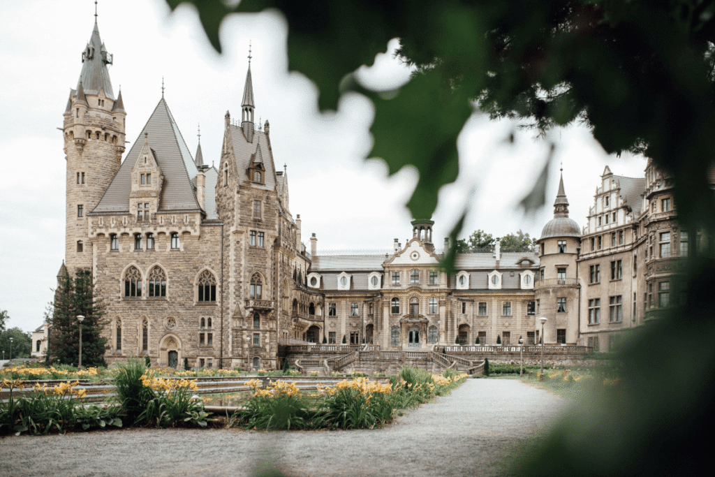 Moszna Castle rises grandly with turrets and gardens, a true fairytale destination in Poland.