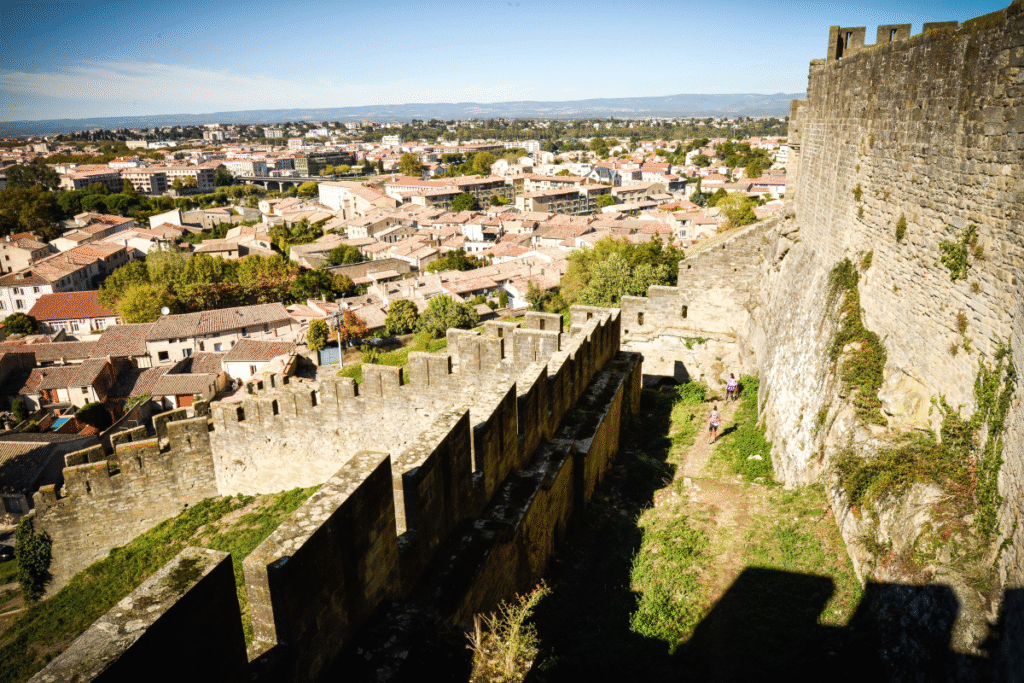 Carcassonne castle walls overlooking the historic cityscape at midday.