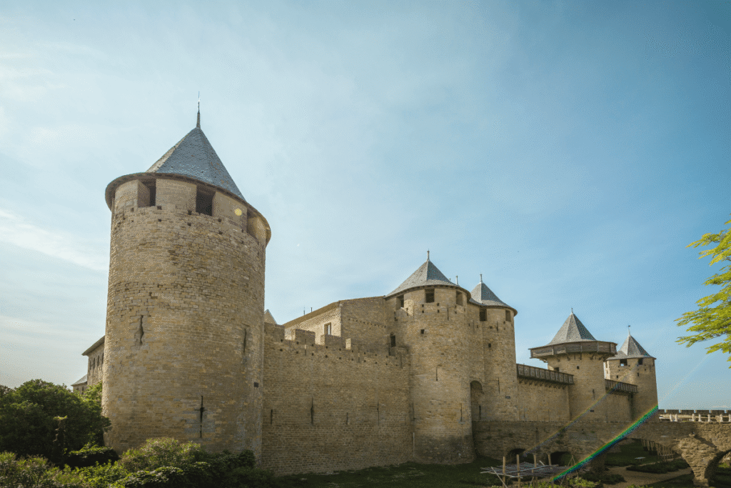 Majestic Carcassonne Castle stone walls and towers under bright blue sky.
