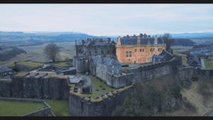 Aerial view of Stirling Castle, iconic Scottish fortress amid scenic landscape.