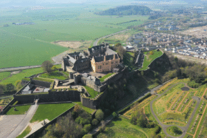 Aerial view of Stirling Castle with lush green surroundings, focus keyword Stirling Castle.