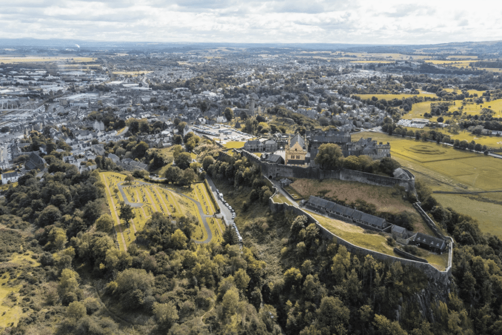 Aerial view of Stirling Castle surrounded by Scottish countryside.