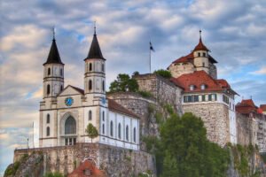Aarburg Castle perched on a rocky cliff under cloudy sky