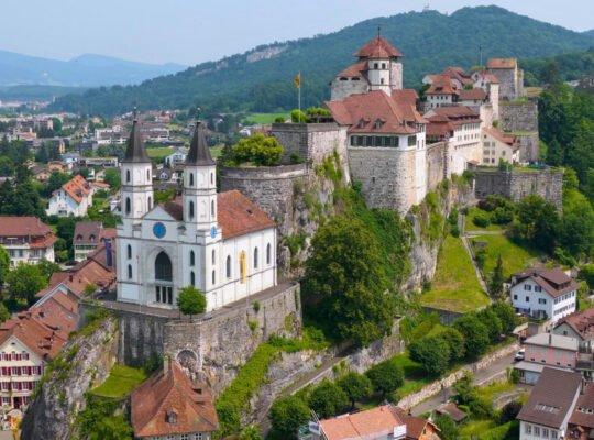 Aarburg Castle atop rocky hill with church and town below