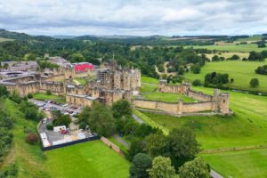 Aerial view of Alnwick Castle and surrounding green landscape