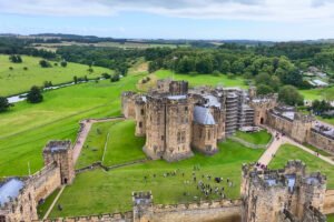 Aerial view of Alnwick Castle and surrounding green parkland