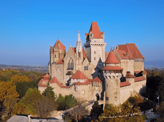Kreuzenstein Castle above autumn forests near Vienna, Austria.