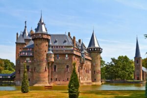 Castle De Haar beside moat with turrets under blue sky