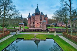Castle De Haar reflected in moat by formal gardens