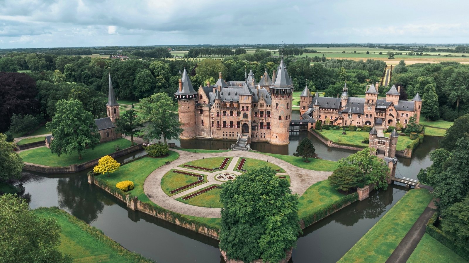 Aerial view of Castle De Haar surrounded by moat and gardens