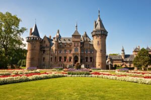 Castle De Haar façade with flower gardens and towers