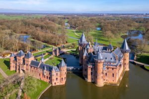 Aerial view of Castle De Haar surrounded by moat and parkland