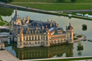 Aerial view of Chantilly Castle surrounded by moat